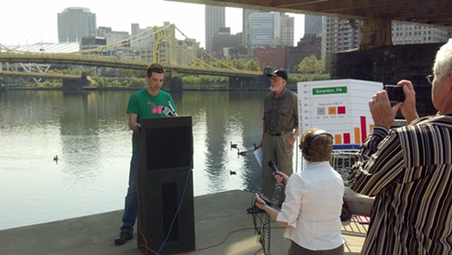 Trevette Hooper, owner of Oaklands Legume restaurant, speaks at a press conference about climate change Thursday under the Roberto Clemente Bridge on the North Side.