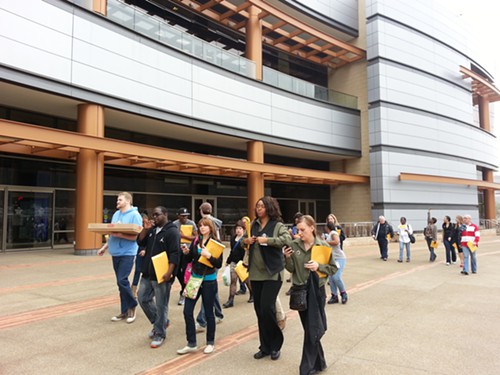Rivers Casino employees deliver a sheet cake announcing union effort to employee dining room.
