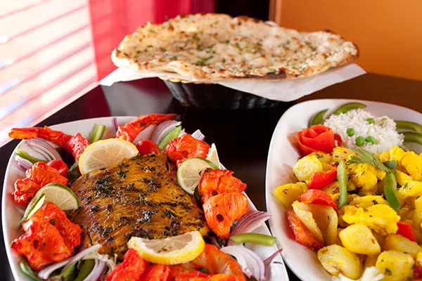 all-india_s-tandoori-shrimp_-chicken_-salmon_-aloo-gobi-and-garlic-nan.webp