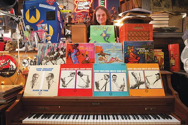 On the record: J. Malls poses in Jerry's Records with some of his collection of vintage album covers by Pittsburgh native Mozelle Thompson.