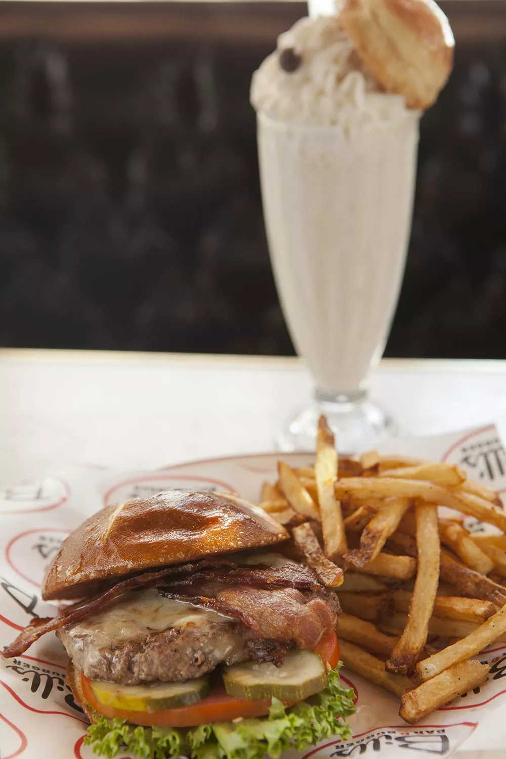 farmhouse-bacon-and-cheddar-burger-with-fries-and-coffee-and-donut-milkshake.webp