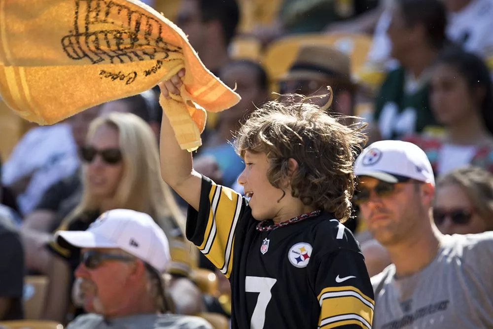 young-steelers-fan-waves-his-terrible-towel.webp