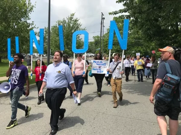Hundreds gather with striking UPMC workers calling for union rights at annual UPMC board meeting