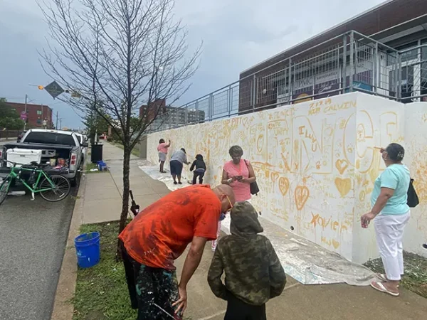 Artists, community volunteers begin painting city’s largest mural