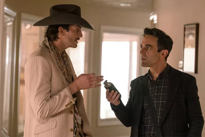 Actor B.J. Novak holds a recording device as s Ashton Kutcher talks in the movie Vengeance.