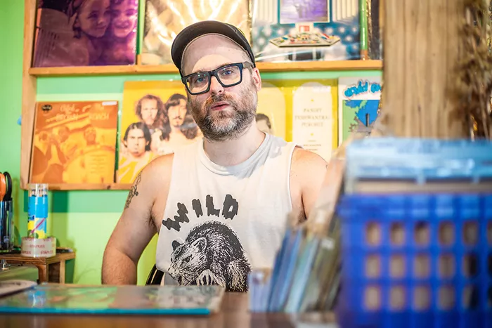 A man behind a counter at a record store