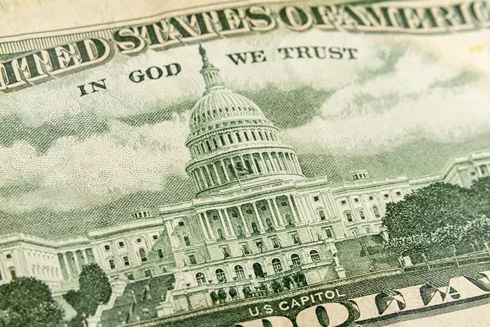A close up of a dollar bill that depicts the U.S. Capitol building