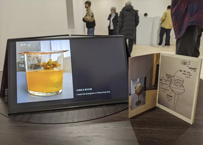 Close-up of a video on a tablet showing how to make a cocktail at the art exhibition HalfDream: Another Room.