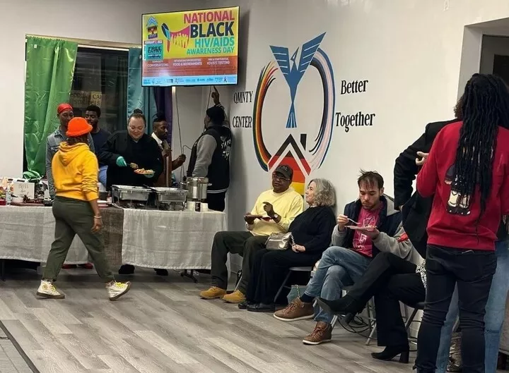 People of different races chat and eat during a National Black HIV Awareness Day event.