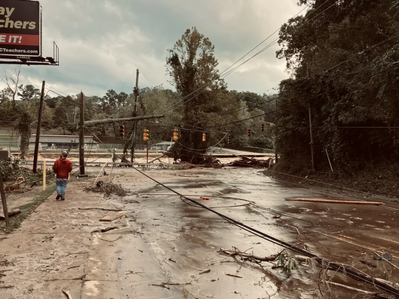 A flooded street surrounded by mud and debris