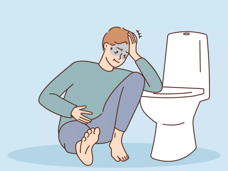 A simple illustration of someone looking ill while clutching their stomach near a toilet