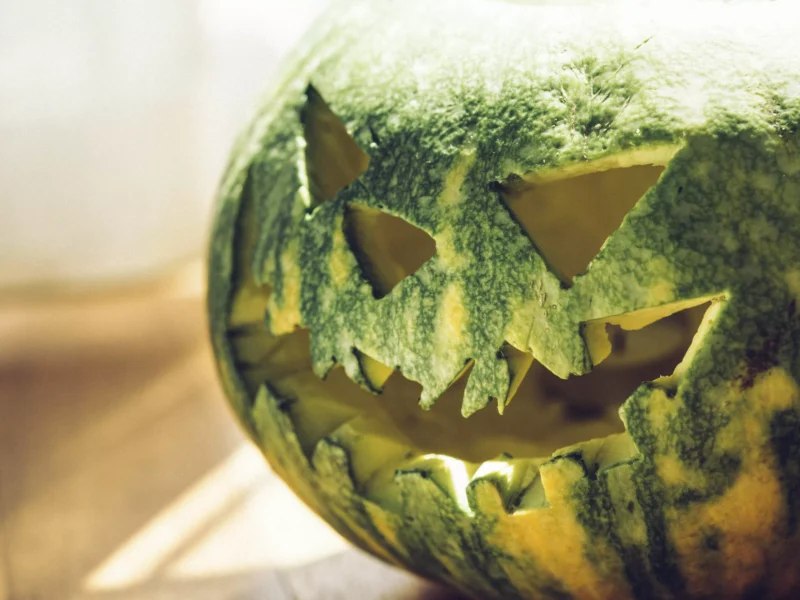 A watermelon carved like a jack-o-lantern