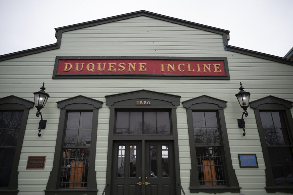 A wood-sided barnlike building with tall windows