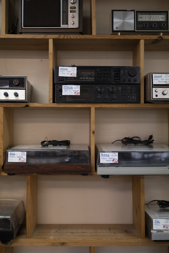 Vintage receivers and turntables for sale on custom wood shelves