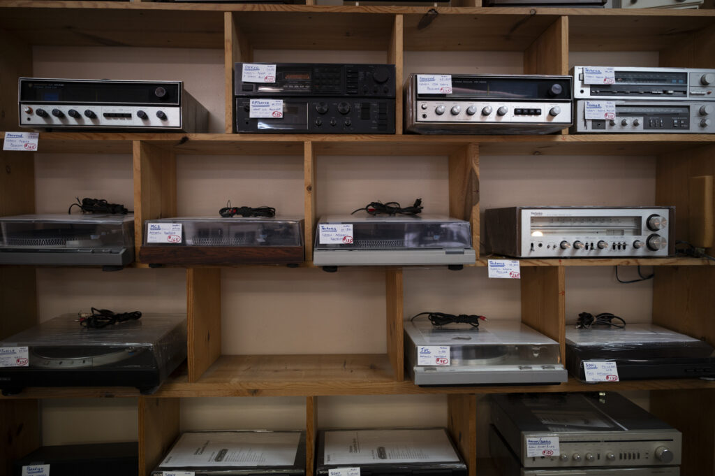 Vintage receivers and turntables for sale on custom wood shelves
